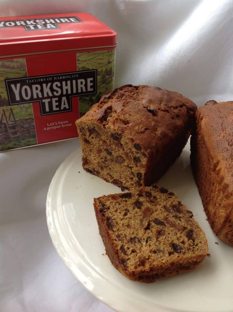Yorkshire Tea loaf on a plate with a Yorkshire Tea, tea caddy.