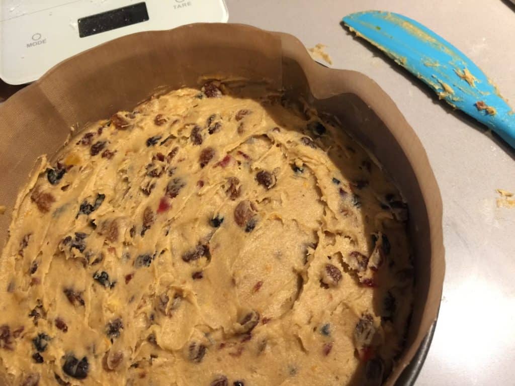 christmas cake batter in a prepared tin lined with baking parchment