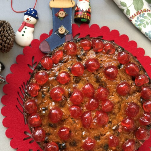 whole Fruit Cake on a red serving mat