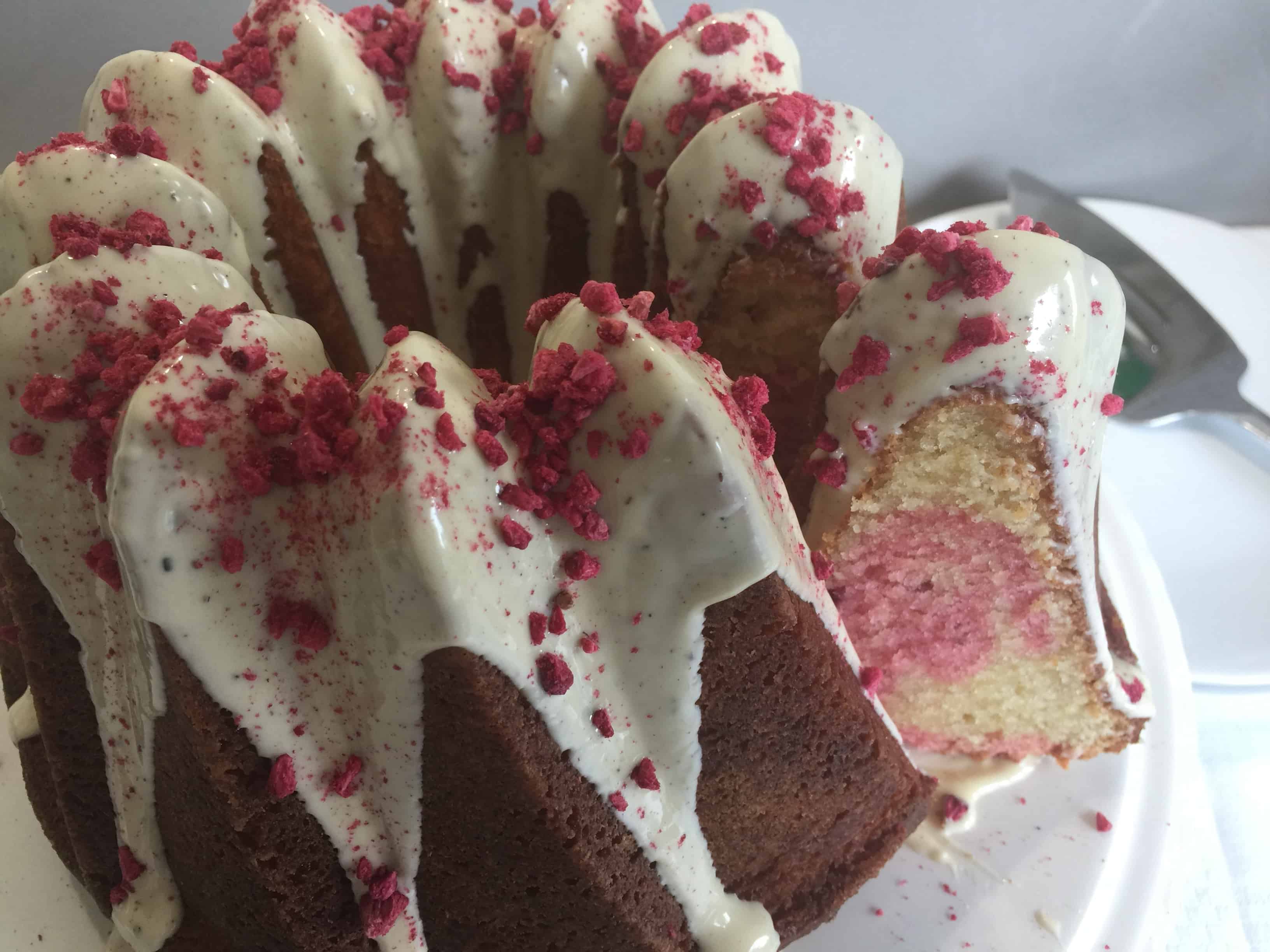 White Chocolate and Raspberry Cake with a slice cut out