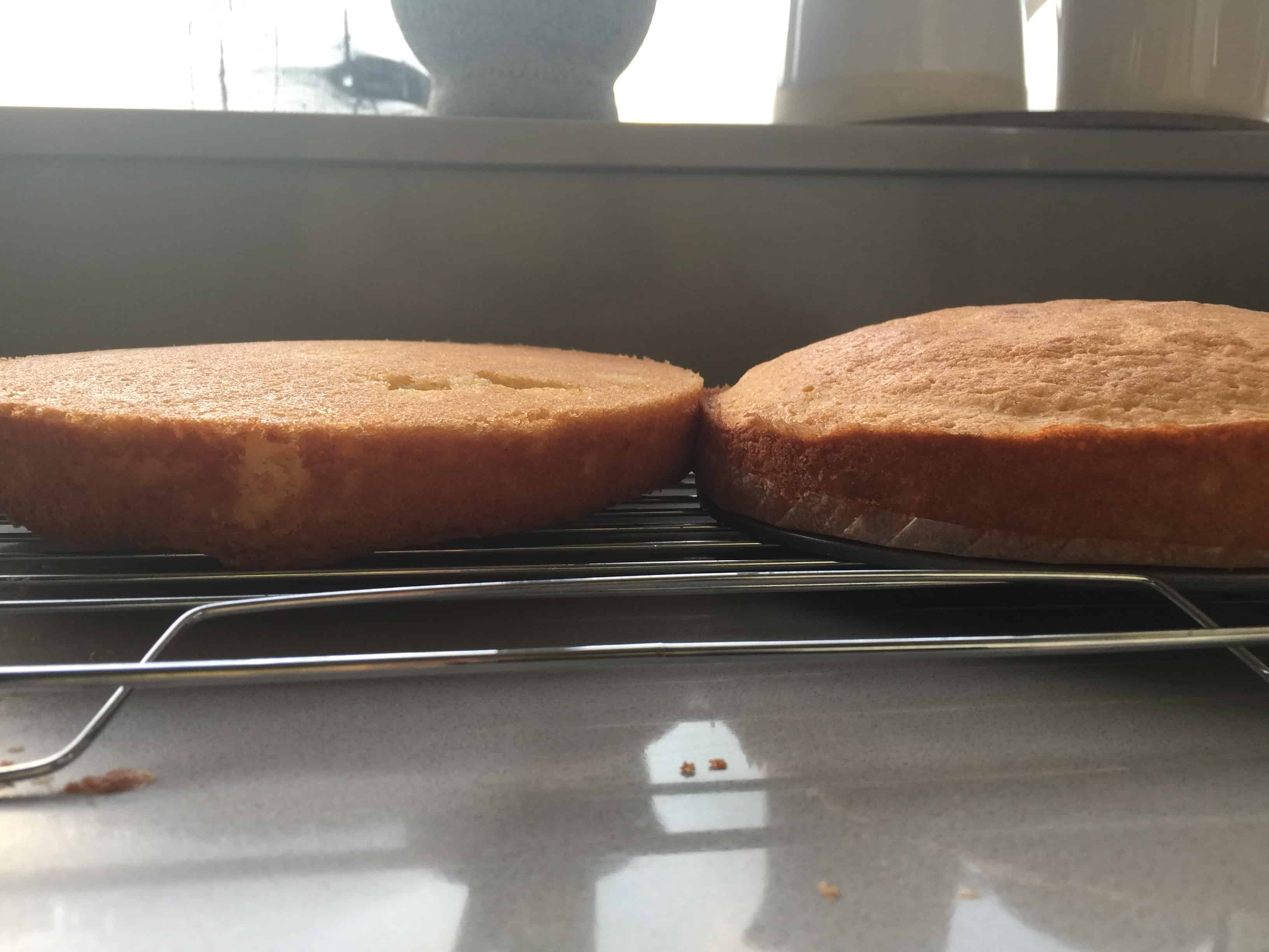 two baked vanilla sponge cakes on a wire rack cooling for victoria sandwich