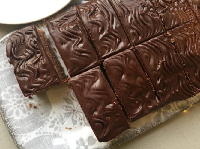 Slices of chocolate cake on a grey patterned tray.
