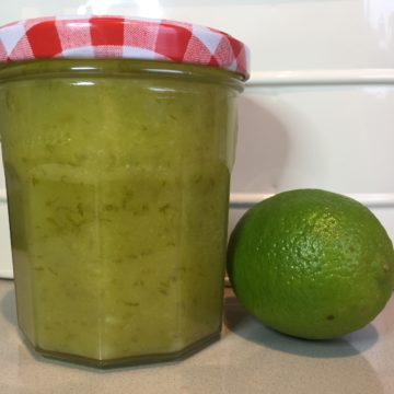 Jar of Lime Curd with a fresh whole lime.