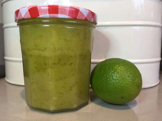 Jar of Lime Curd with a fresh whole lime.