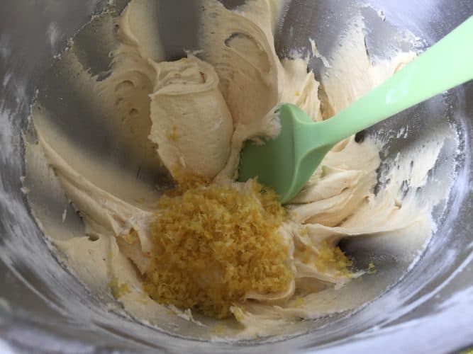 Lemon zest and cake batter in a mixing bowl.