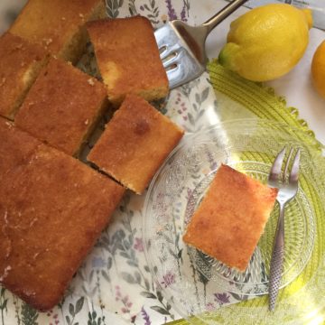 Slices of cake with lemons on the side.