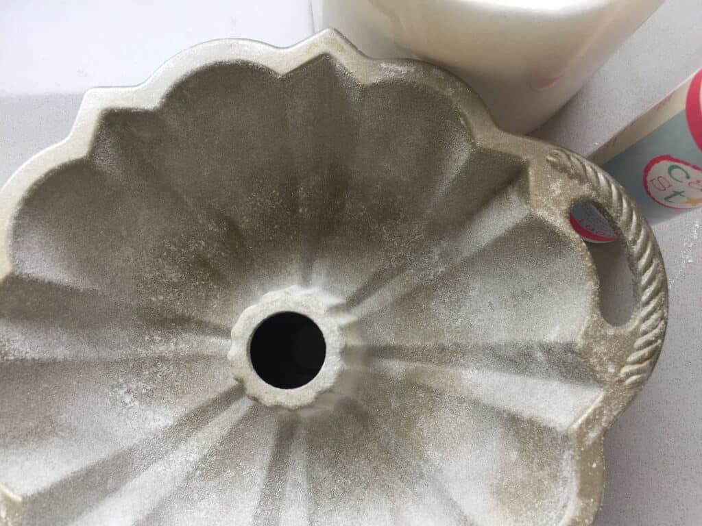 The inside of a 6 cup Bundt pan greased and coated