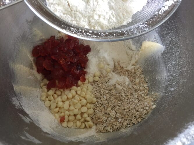 Glace cherries, oats, flour and butter in a mixing bowl.