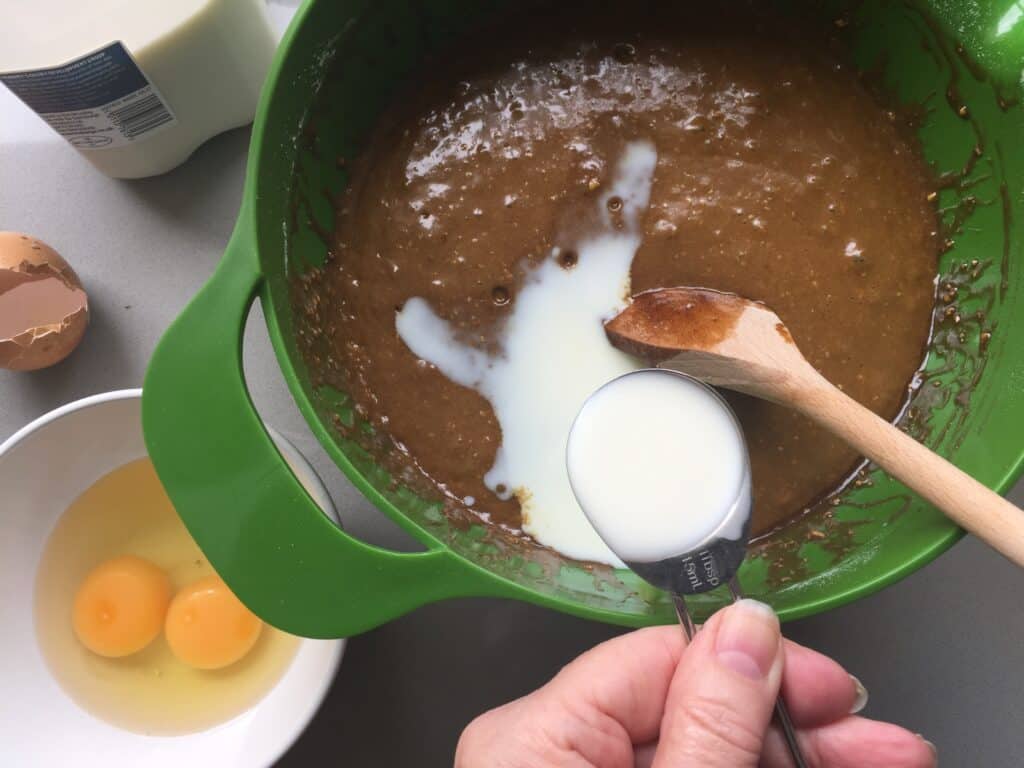 Add the milk and eggs to the Parkin cake batter