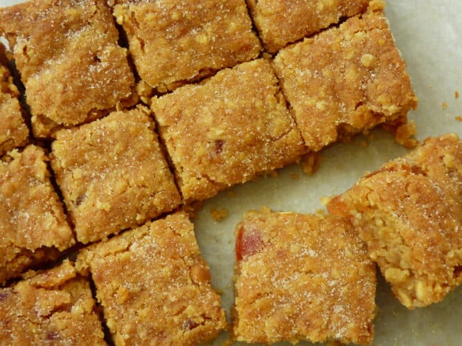 Cherry, Oat and White Chocolate Cookie Bars cut into small square slices