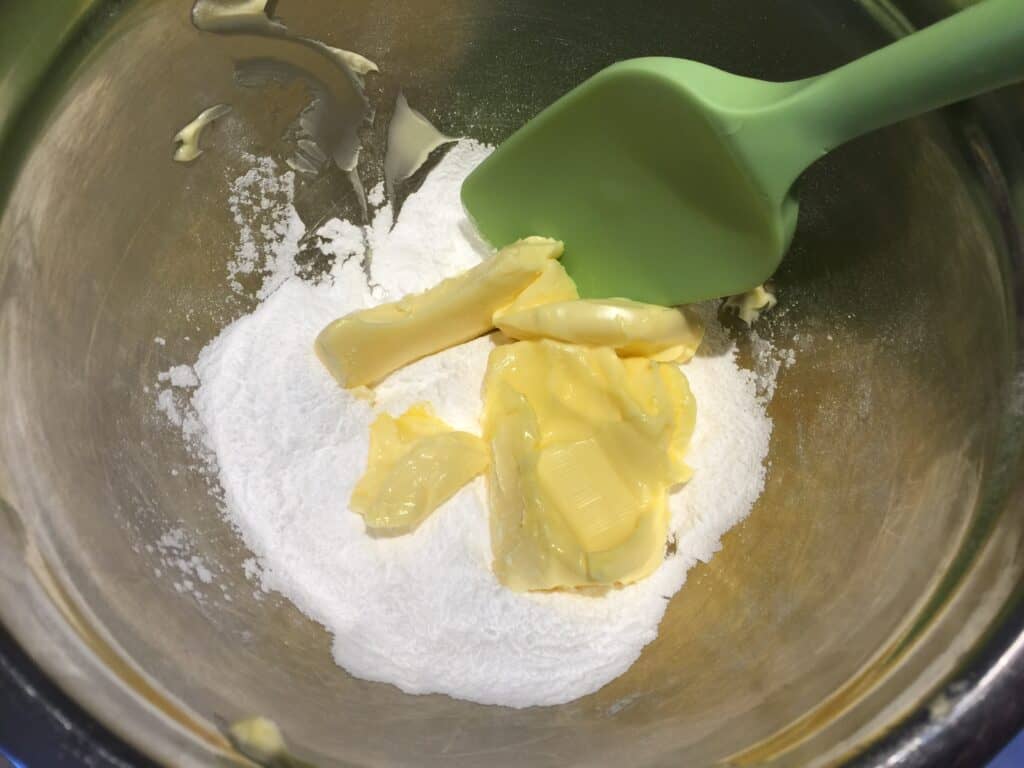 butter and icing sugar in a bowl
