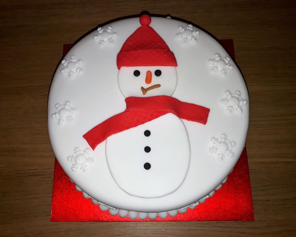 Fondant covered cake with snowman and snowflakes