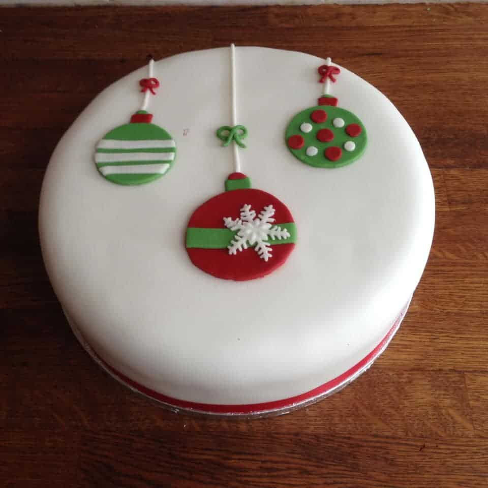 Fondant covered cake with three christmas bobbles
