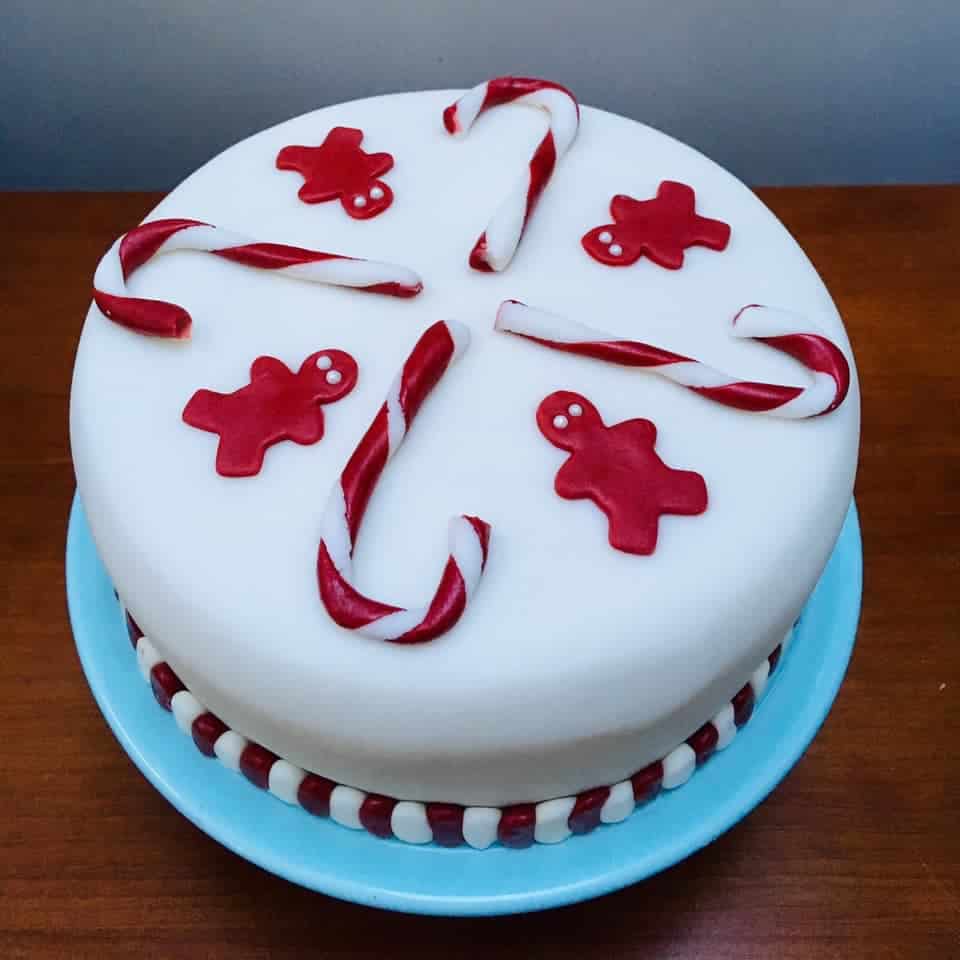 Fondant covered cake with candy canes and gingerbread men