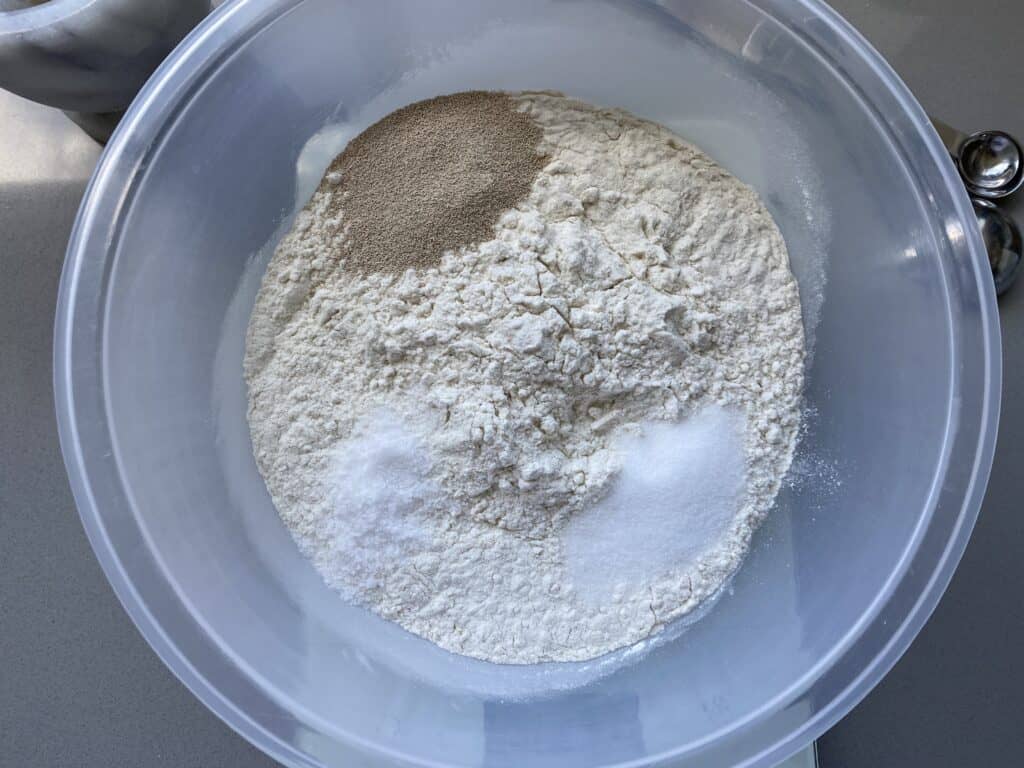 Bread ingredients in a clear mixing bowl