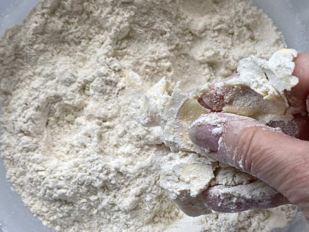 Butter and flour in a hand over a mixing bowl