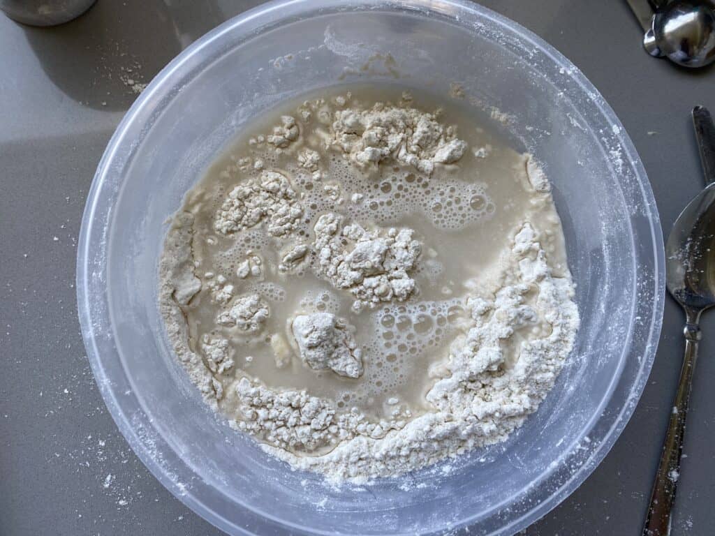 Wet and dry bread ingredients in a mixing bowl