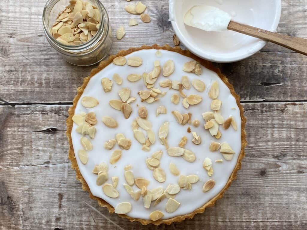 Baked Tart on a counter top with flaked almonds