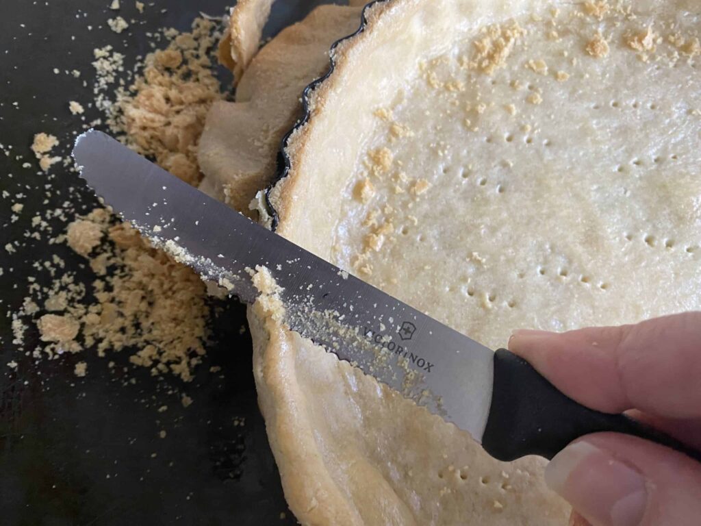 Slicing the edges of a baked pastry case