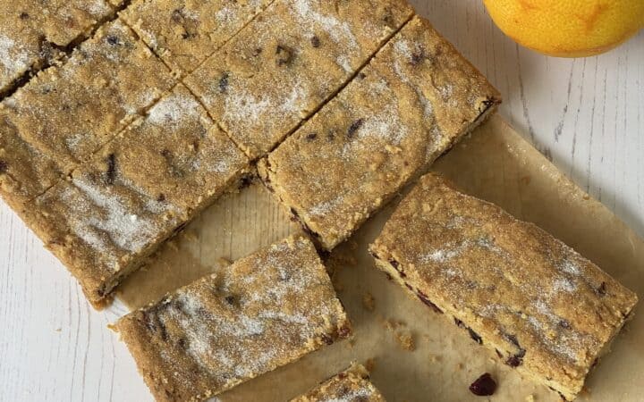Slices of Cookie Bars with two oranges.