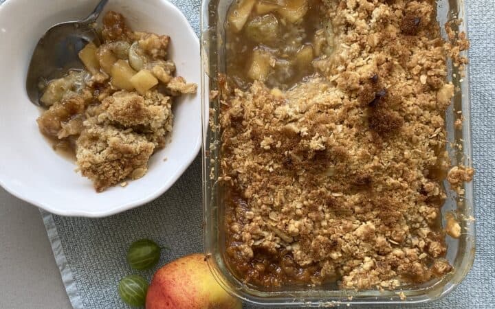 Serving of Gooseberry and Apple Crumble in a white dish