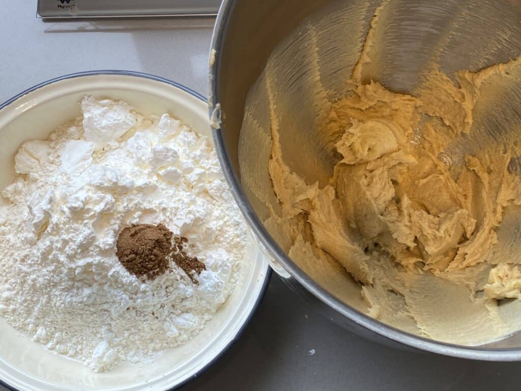 Dry flour ingredients in a bowl and cookie batter in a bowl