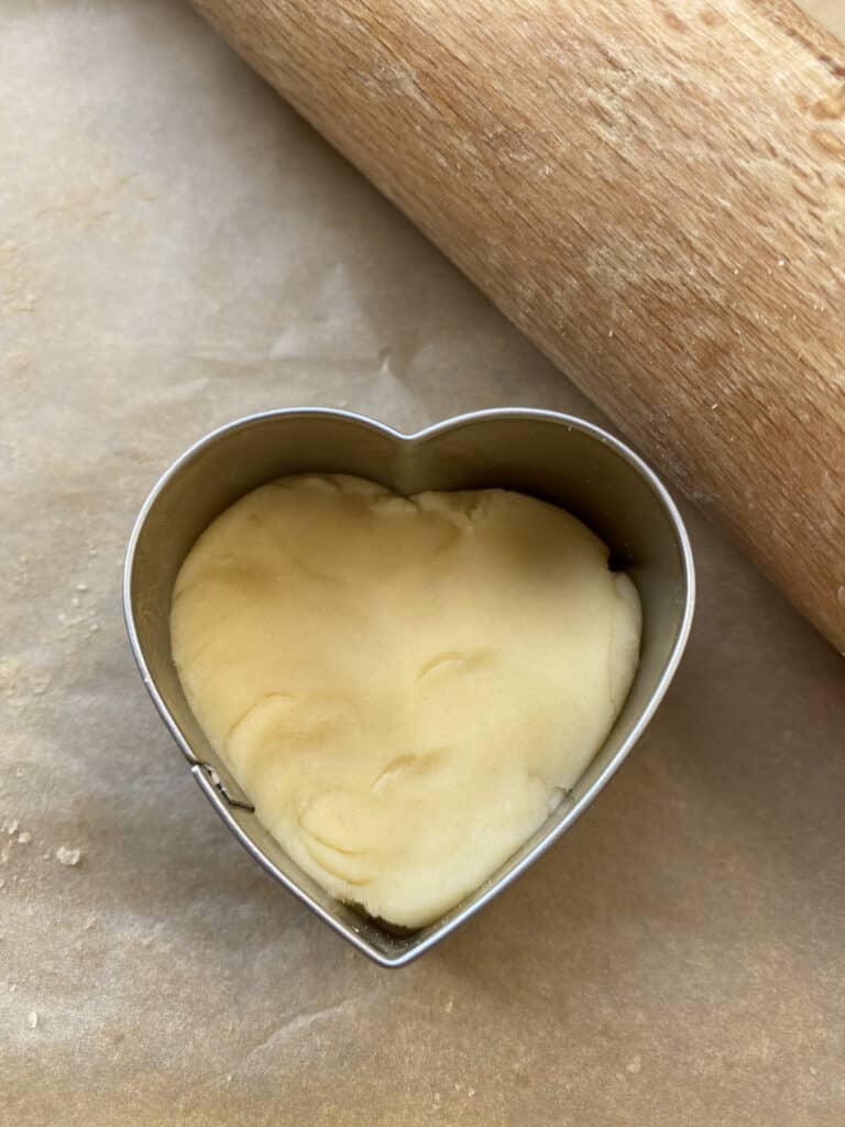 Heart shaped biscuit cutter with dough in the middle