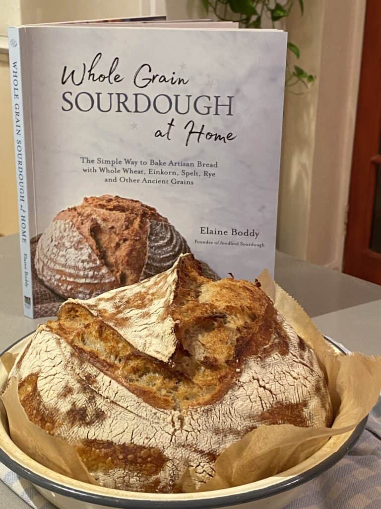 Sourdough Cook book with a baked loaf in a baking tin
