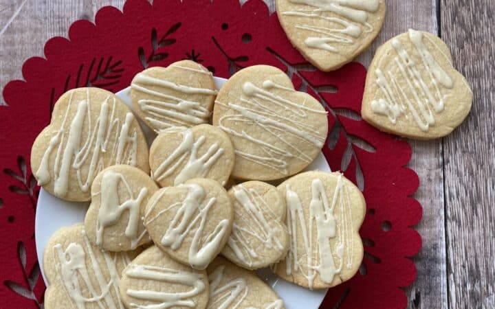 Heart shaped biscuits on a plate and red serving mat