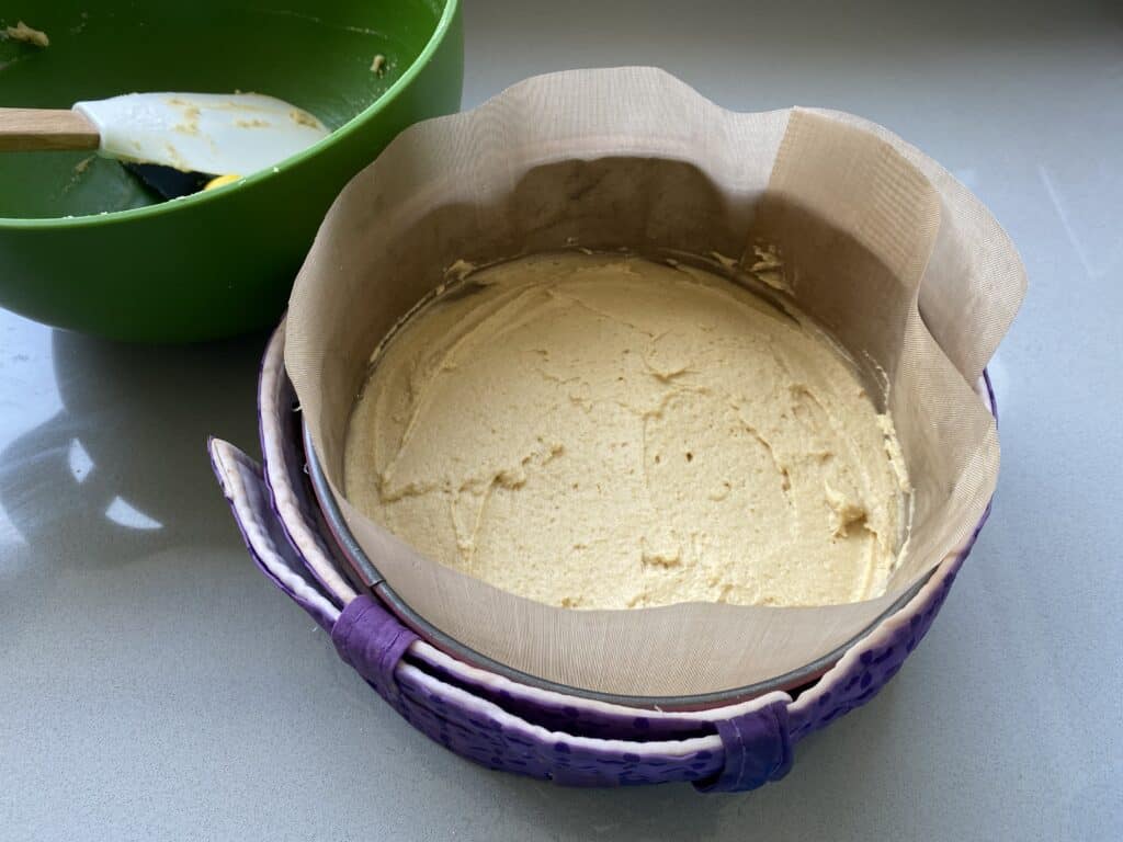 Cake batter in a lined cake tin
