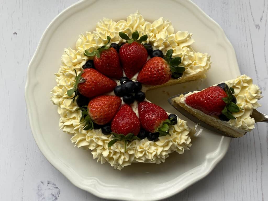 Summer Berry Cake with a slice cut out.