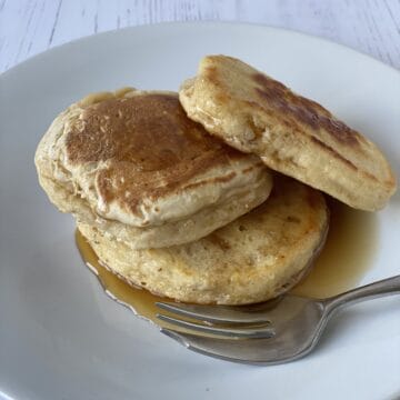 3 Pancakes on a white plate with a small fork