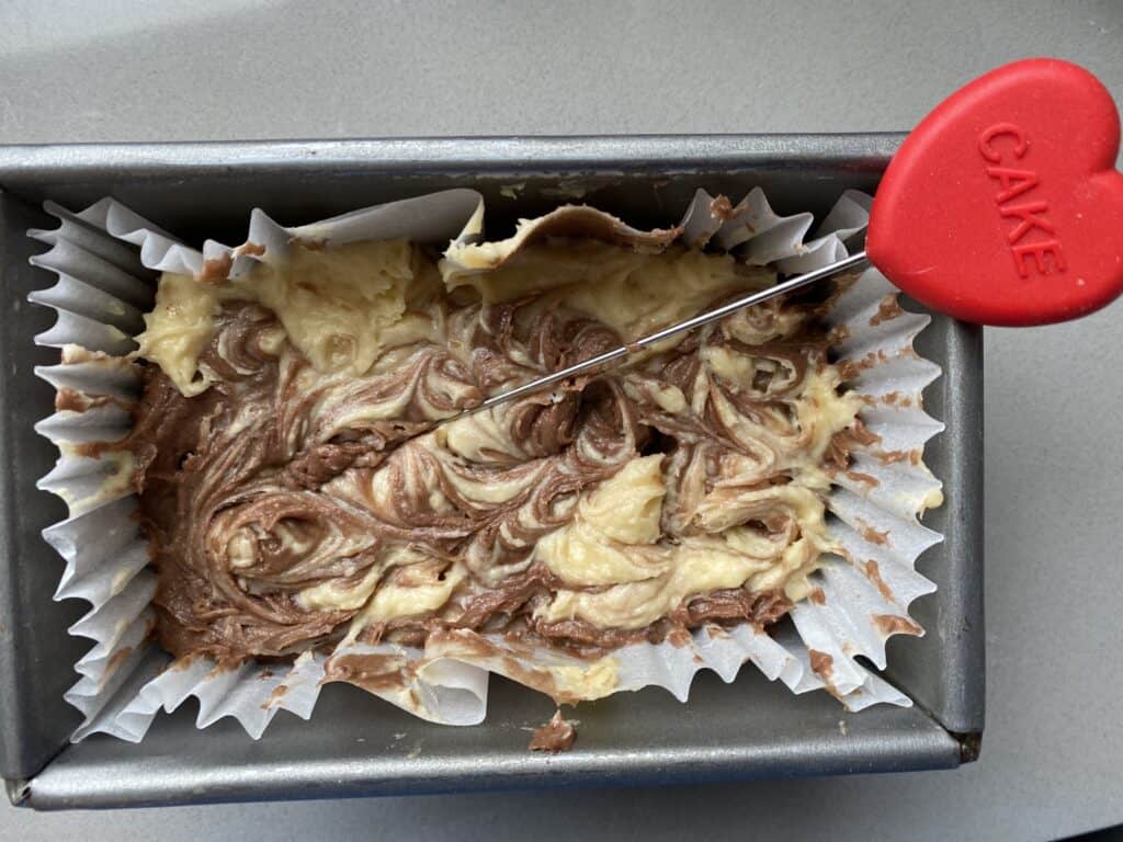 Use a cake skewere to swirl the cake batter in the cake tin