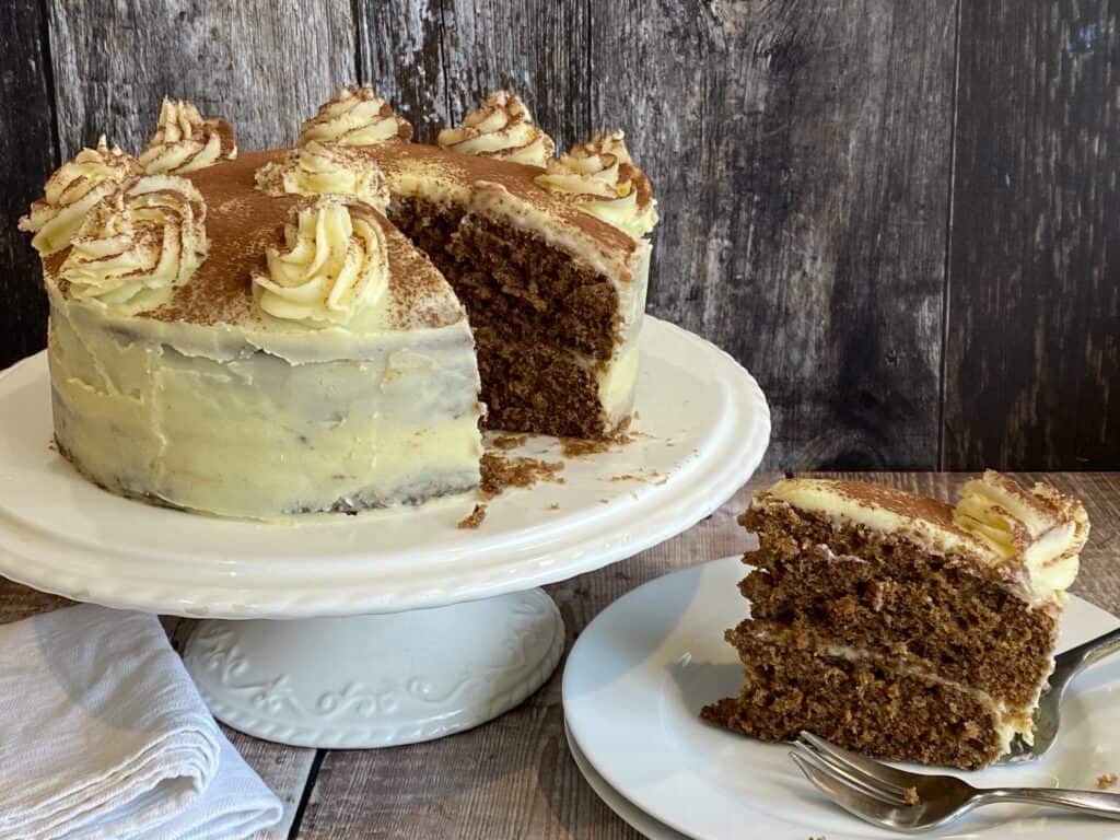 White Chocolate Mocha Cake with a slice cut out on a white plate.