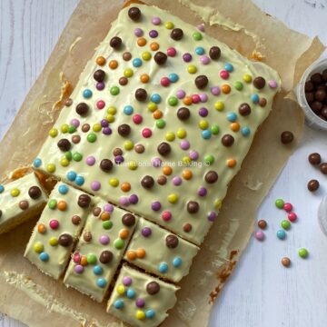 White Chocolate and Candy cake with a slice cut out.